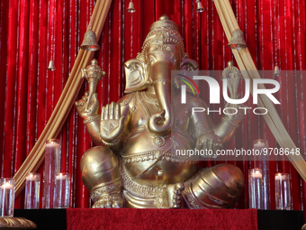 Large idol of Lord Ganesh surrounded by candles during a Hindu wedding in Scarborough, Ontario, Canada. (
