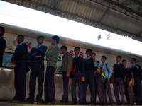Indian students stand in a queue as they wait to get entry inside science express train at the Rambagh railway station in Allahabad on Decem...