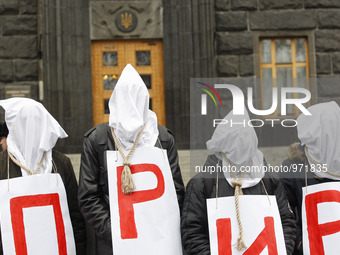 Ukrainian activists who are suffering from HIV AIDS and hepatitis stand with bags on their heads and the noose around his neck as a symbol t...