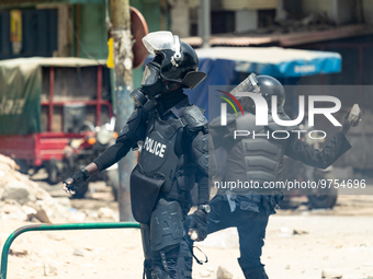 A police officer throwing a rock, in Dakar on March 16, 2023. Security forces were deployed in the Senegalese capital  ahead of a politicall...