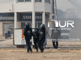 Police officers carry another police officer injured by protesters, on March 16, 2023. Security forces were deployed in the Senegalese capit...