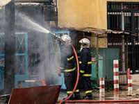 Firefighters put out a burning shop in Dakar on March 16, 2023. Supporters of Ousmane Sonko came out to protest and show support before his...
