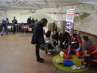 People listen to an instructor during a first aid training at one of the metro stations in Kyiv, Ukraine, on March 17, 2023. Specialists and...