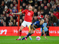 Jonjo Shelvey of Nottingham Forest puts pressure on former teammate, Bruno Guimaraes of Newcastle United during the Premier League match bet...