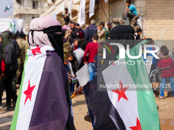 Syrians raise the flags of the revolution and chant in major demonstrations to celebrate the twelfth anniversary of the Syrian revolution ag...