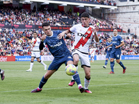 Sergio Camello of Rayo Vallecano (R) battles for the ball with Arnau Martinez of Girona FC (L) during a match between Rayo Vallecano v Giron...