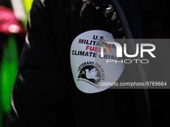 A demonstrator wears a sticker during an anti-war protest in Washington, D.C. on March 18, 2023. The protest, organized by the Answer Coalit...