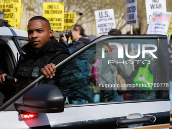 A United States Secret Service officer watches protestors during an anti-war protest in Washington, D.C. on March 18, 2023. The protest, org...