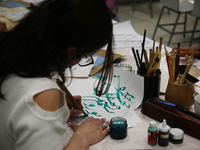 People take part in a traditional Farsi calligraphy workshop during Nevruz celebrations in Toronto, Canada, on March 18, 2023. Nevruz (Noroo...