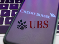 Credit Suisse logo displayed on a phone screen and UBS logo displayed on a laptop screen are seen in this illustration photo taken in Krakow...