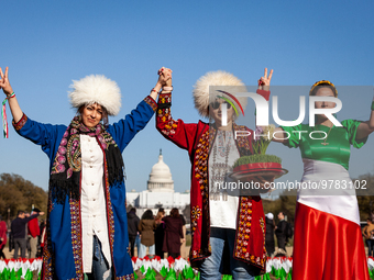 Three women participate in a Nowruz celebration on the National Mall. The holiday has its roots in Zoroastrianism and celebrates rebirth and...