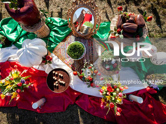 Items celebrating Nowruz sit on an Iranian flag during an event marking the holiday on the National Mall. The holiday has its roots in Zoroa...