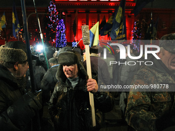 Hundreds of activists and supporters of Ukrainian nationalists march with torches and flags in downtown Kiev during a rally confined to the...