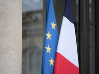 The French and European flags at the entrance to the Elysee Palace, in Paris, on March 27, 2023. (