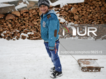 Bulgarian Mohammedan boy or also called pomaks play with their sleds as heavy snow falls in the village of Ribnovo, Blagoevgrad on January 0...