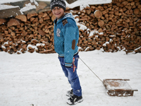 Bulgarian Mohammedan boy or also called pomaks play with their sleds as heavy snow falls in the village of Ribnovo, Blagoevgrad on January 0...