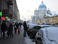 People walk along the avenue with views of the Trinity Cathedral in St. Petersburg. Russia, Tuesday, January 5, 2015 Temperatures dipped to...