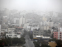 A picture taken on  08 January 2016.  shows a general view of Gaza City shrouded in a thick cloud of dust during a sandstorm. A dense sandst...