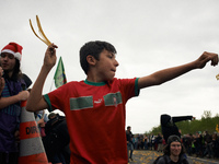 A boy throws a banana peel during a banana peels battle during the march. More than 8000 protesters marched 12km against the planned A69 hig...