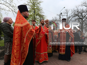 Orthodox priests conduct a service during a commemoration ceremony marking the 37th anniversary of the Chernobyl disaster next to a memorial...