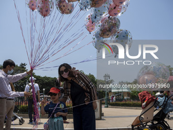 People holding balloons at Hong Kong Disneyland on April 28, 2023 in Hong Kong, China. (