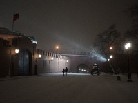 People walk during a heavy snowfall in Moscow, Russia, on January 12, 2016.  (