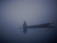 SRINAGAR, INDIAN ADMINISTERED KASHMIR, INDIA - JANUARY 13: A Kashmiri boatman rows his boat during a cold foggy day on January 13, 2016 in S...