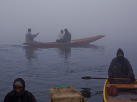 SRINAGAR, INDIAN ADMINISTERED KASHMIR, INDIA - JANUARY 13: A Kashmiri boatman rows his boat during a cold foggy day on January 13, 2016 in S...