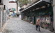 A woman is walking on alley in the center of Athens, Greece on May 3, 2023. 