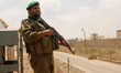 Palestinian Hamas security guards stand near an Egyptian watch tower on the border with Eg...