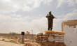 Palestinian Hamas security guards stand near an Egyptian watch tower on the border with Eg...