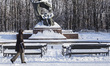 Woman walks past monument of Polish composer and pianist Frederic Chopin covered whith sno...