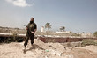Palestinian Hamas security guards walk near an Egyptian watch tower on the border with Egy...