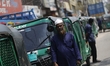 Drivers in a queue to get fuel near a gas station during a power and fuel crisis in Dhaka,...
