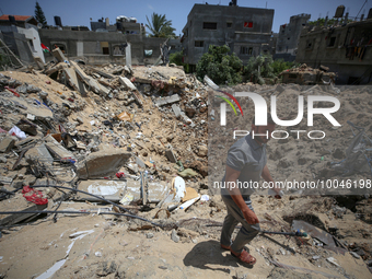 A Palestinian man walks amidst the rubble of his house in Gaza City, on May 15, 2023, following a ceasefire ending five days of deadly fight...