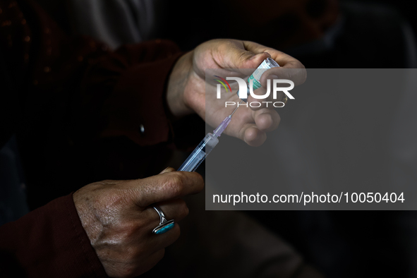A health worker fills a Syringe with Vaccine during a Vaccination drive ahead of Hajj pilgrimage at SDH Sopore District Baramulla Jammu and...