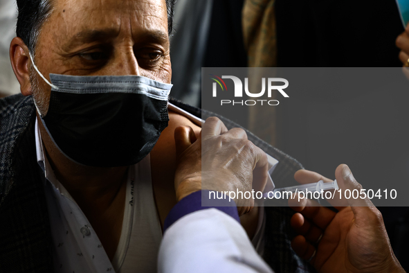 A man recieves a dose of Vaccine during Hajj pilgrimage vaccination program in Sopore District Baramulla Jammu and Kashmir India on 16 May 2...