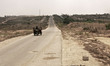 Palestinian Hamas security guards walk near an Egyptian watch tower on the border with Egy...