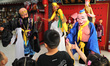 Performers of a puppet art troupe perform a puppet show for children in Qingdao, Shandong...