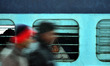 An indian boy ,covering himself with shawl,peeps outside ffrom a train window, at Allahaba...
