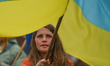 KRAKOW, POLAND - MAY 20, 2023: A Ukrainian activist holds a Ukrainian flag during a daily...