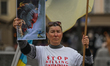 KRAKOW, POLAND - MAY 20, 2023: A Ukrainian activist holds a poster featuring Russian Pres...