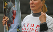 KRAKOW, POLAND - MAY 20, 2023: A Ukrainian activist holds a poster featuring Russian Pres...