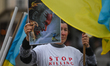 KRAKOW, POLAND - MAY 20, 2023: A Ukrainian activist holds a poster featuring Russian Pres...