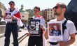 Protesters hold banners during a demonstration of support and solidarity with Belarusian p...