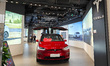 Customers experience a Tesla electric car at a Tesla store in Shanghai, China, May 23, 202...
