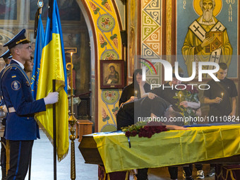 Relatives of Mikola Vasiliovich lie on his coffin during a holy mass in Saint Michael's Golden Domed Cathedral. Mikola was a ukrainian soldi...