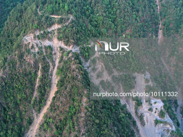 MULI, CHINA - MAY 30, 2023 - Firefighters survey the mountain road of Muli fire site in Muli County, Liangshan, Sichuan province, China, May...