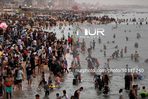 Palestinians enjoy the beach of the Mediterranean Sea on the coast of Gaza City, on June 2, 2023, during a heat wave. 
