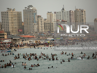 Palestinians enjoy the beach of the Mediterranean Sea on the coast of Gaza City, on June 2, 2023, during a heat wave. (